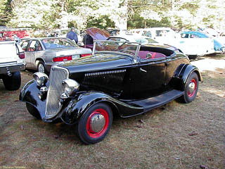 1934 Ford roadster. It has a canvas, fold down roof but no side windows.