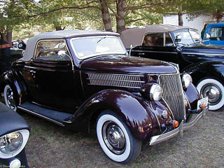 1936 Ford Cabriolet. It has a fold down, canvas roof and also has side windows.