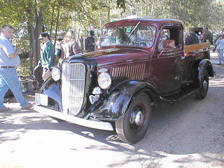 Maroon 1936 Ford pickup truck with black fenders