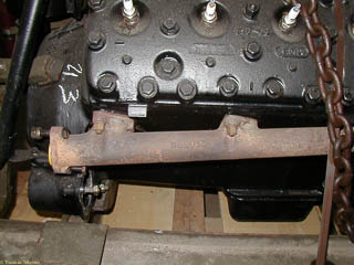 Left exhaust manifold and cast bell housing on French flathead V8