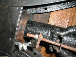 Parking brake cable attached to brake handle