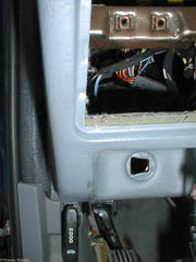 The hole in the dash for the parking brake release handle is not square