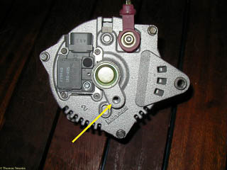 Rear of replacement alternator. Arrow shows where rear bolt is attached. This is difficult toget access to when removing the old alternator.