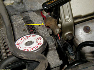 Arrow points to last wire that must be removed. There is a nut under this plastic cover.