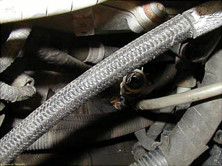 Lower section of speedometer cable showing the hair-pin clip that holds the upper half in place